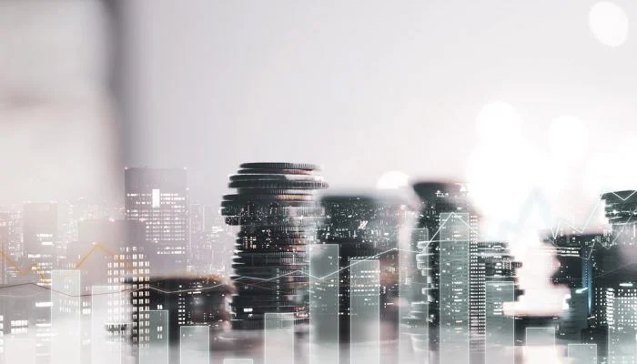 Stylized image of a city, graphs and coins.